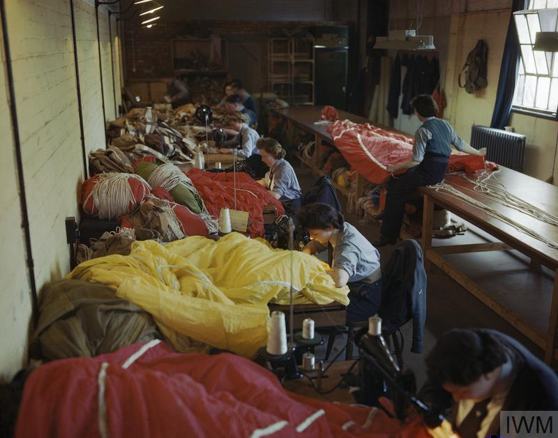 Members of the Women’s Auxiliary Air Force (WAAF) preparing parachutes for use by British airborne forces during the invasion of Europe, May 1944. (Image: IWM)